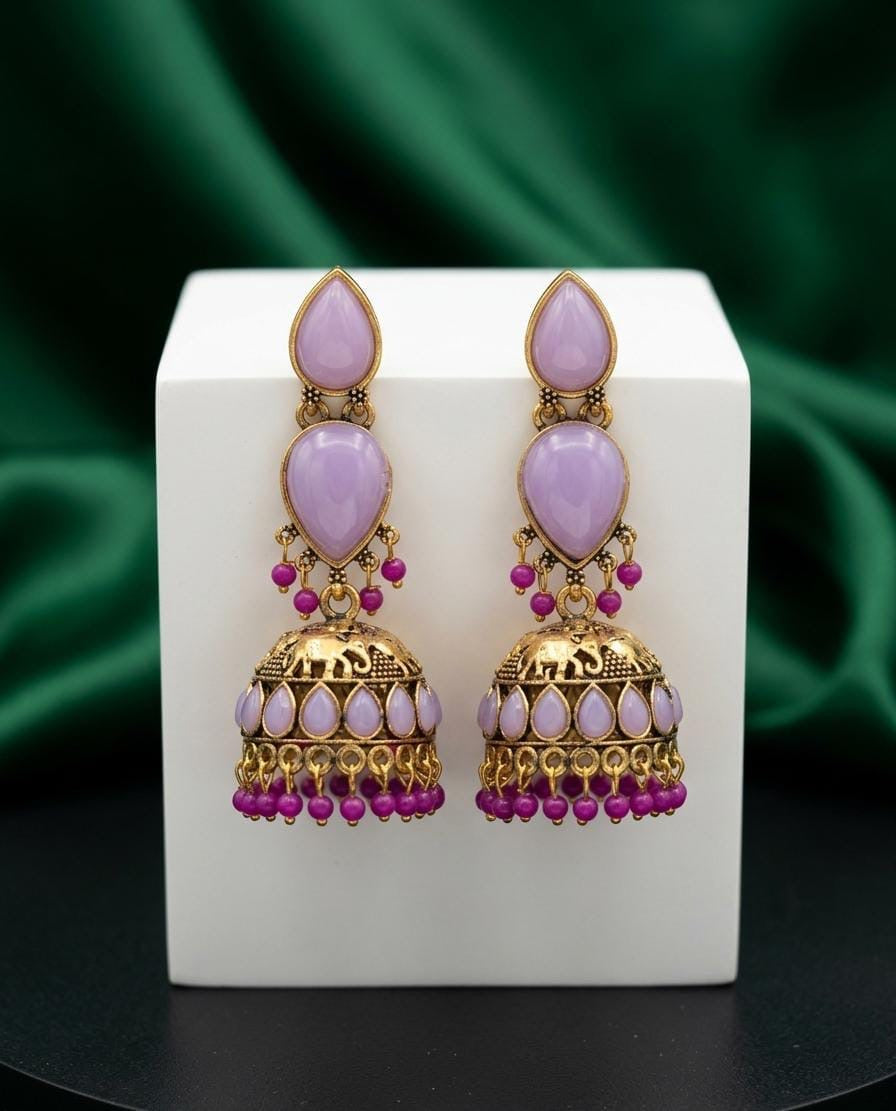 Ornate earrings with pink stones and gold accents