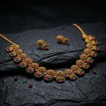Gold necklace and earrings with gemstones