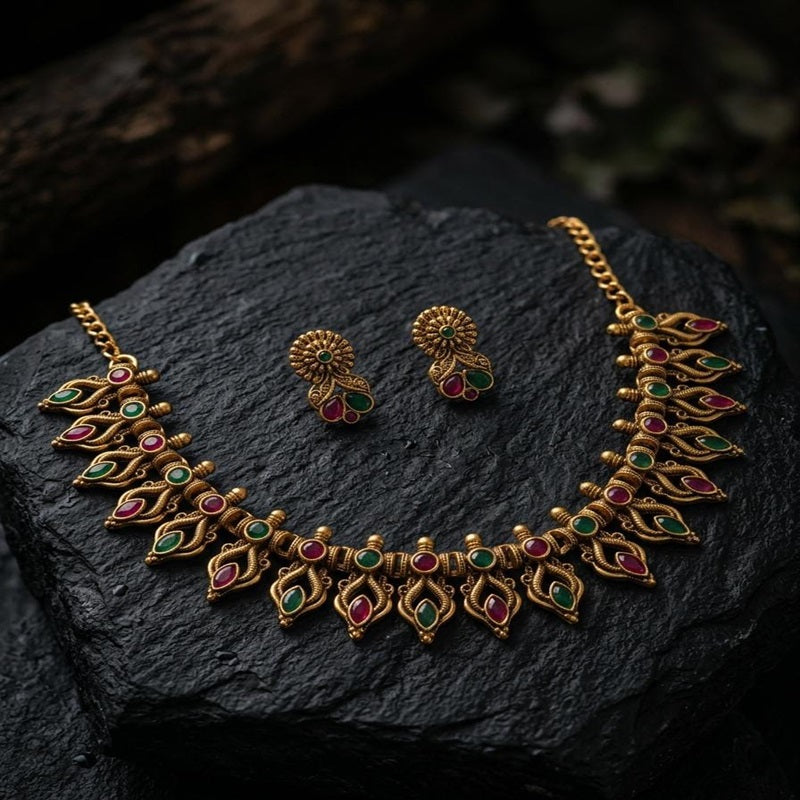 Gold necklace and earrings with gemstones