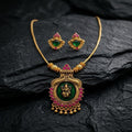 Gold necklace with green and red stones